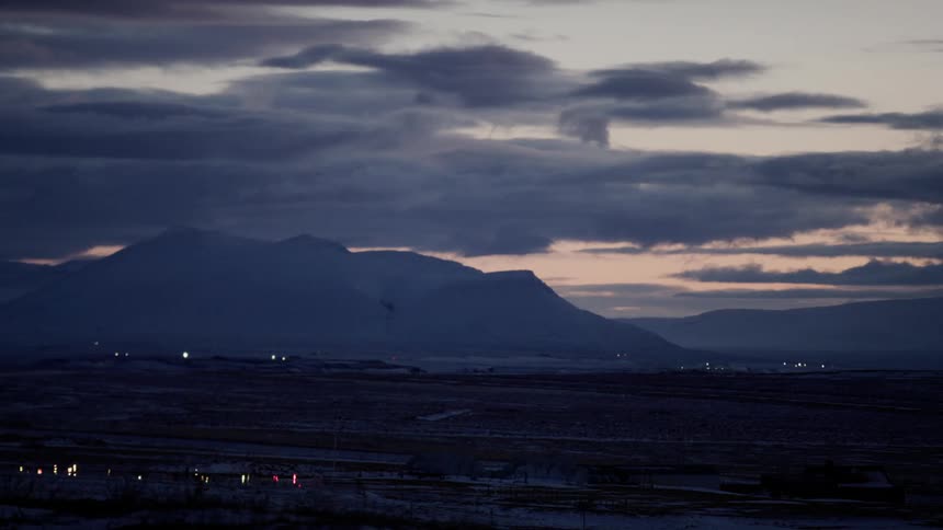 Rural industrial area on the plains next to the mountains at evening