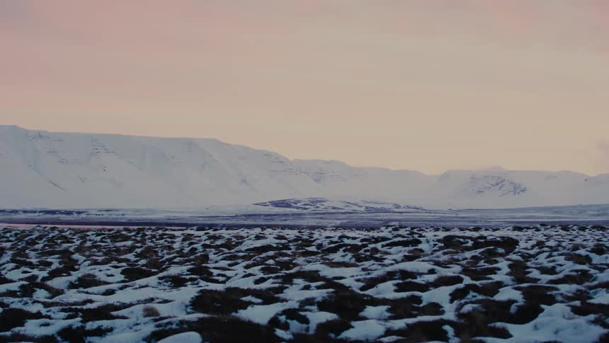 The sun is setting in the arctic landscape