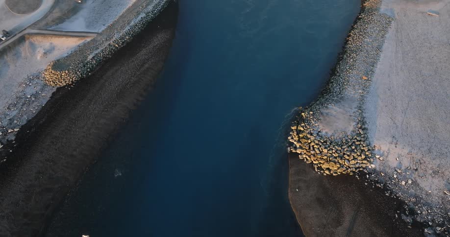 Aerial view of aqueduct moving toward bridge and horizon during the day