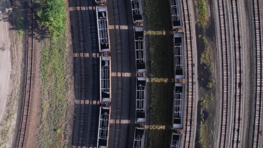 An aerial view of trains and empty train tracks