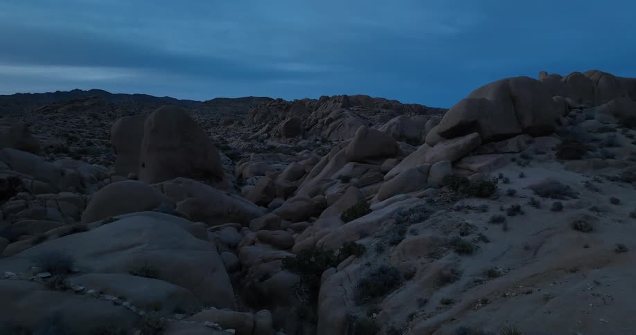Aerial view of the boulders and rocks on a mountain in the desert at evening