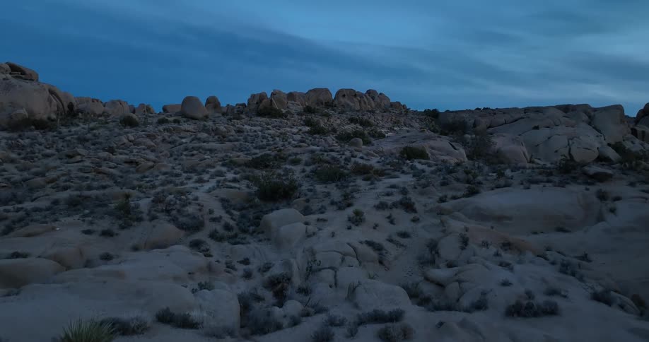 Scrub covers land between boulders and rock outcroppings