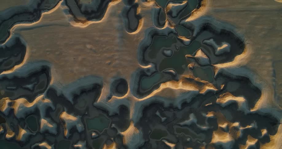 Water fills area between elevated layer of land