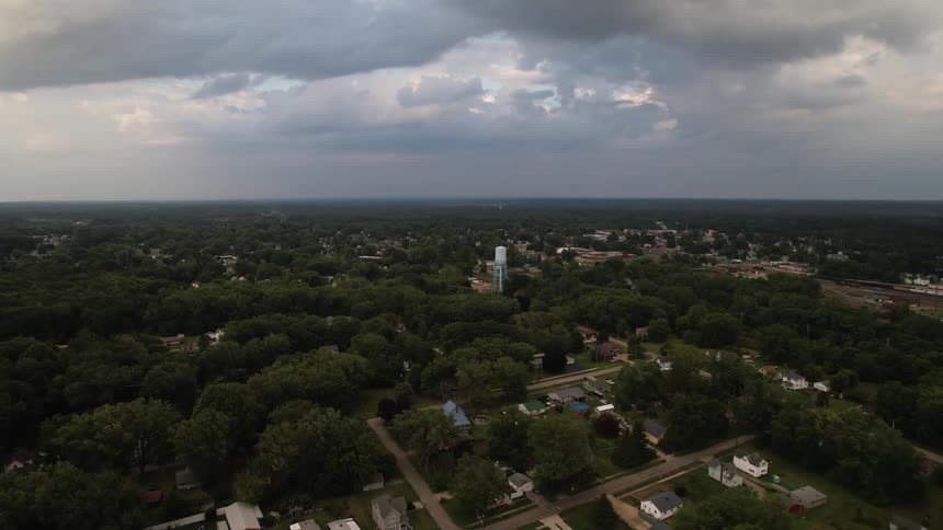 Aerial view of a small town in the plains under a cloudy sky at evening