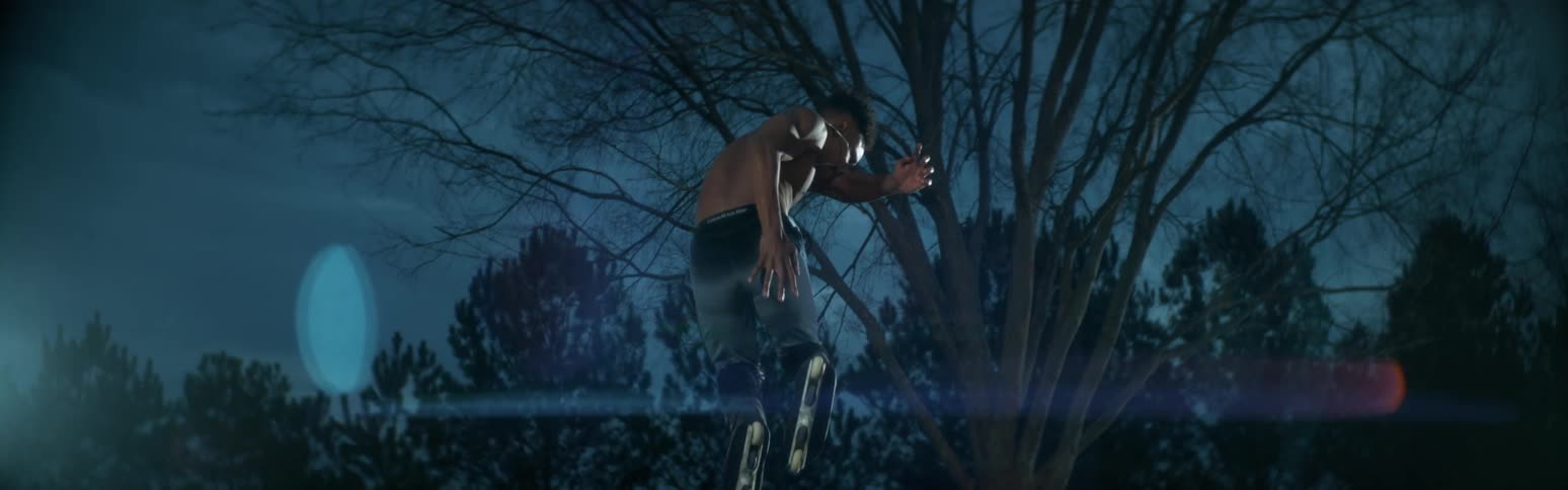 Slow motion of a man jumping outdoors during the night