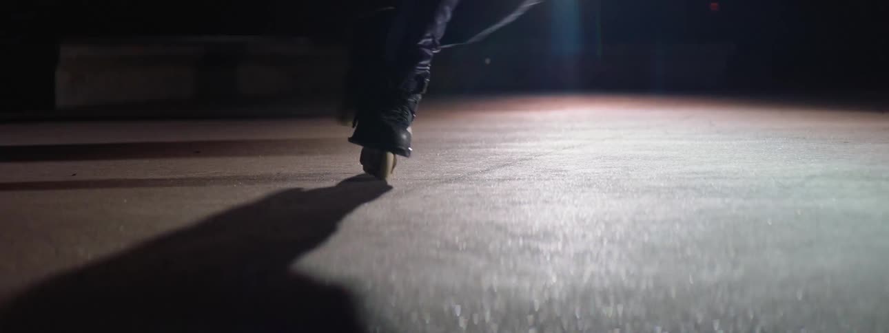 A persons feet on roller skates rolling around on pavement