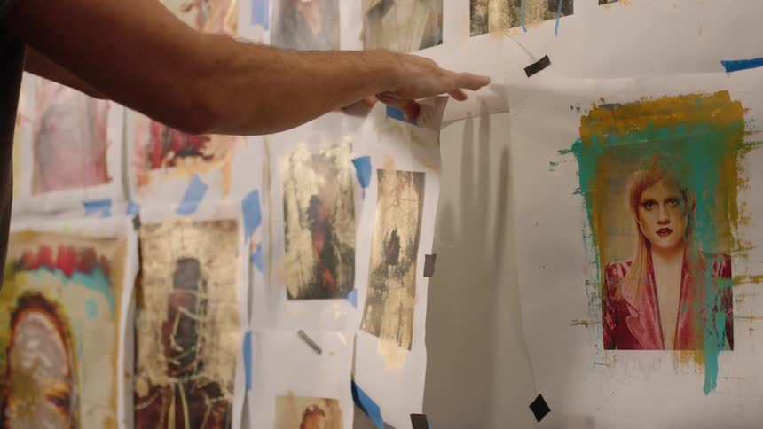 Artist takes a painting off the wall