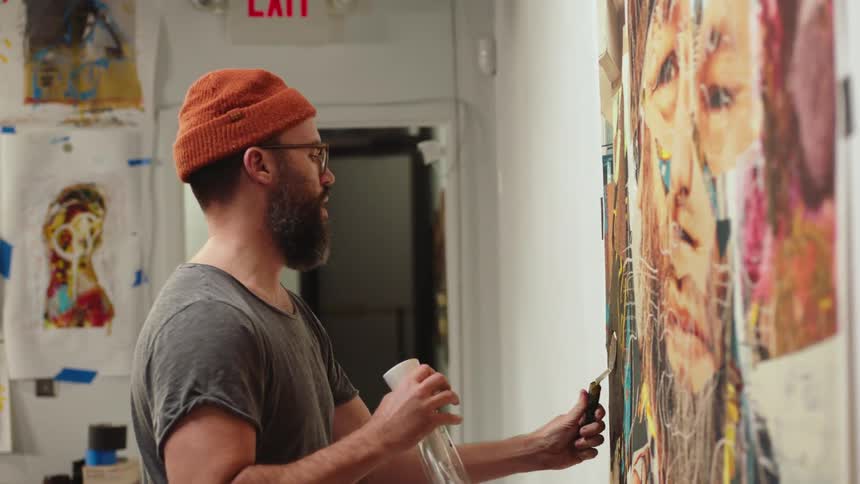 Artist painting a mural on an indoor wall