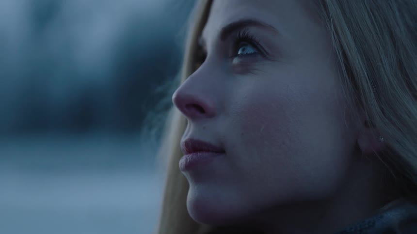 A woman looks up at a person next to her