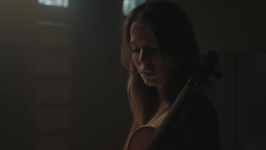 Woman stands with a violin