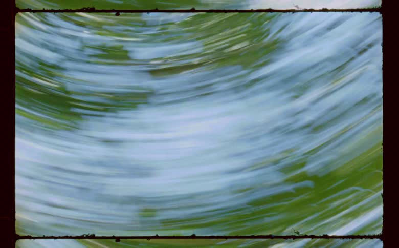 Spinning rotating speed turns sky and plants into blue and green blurs