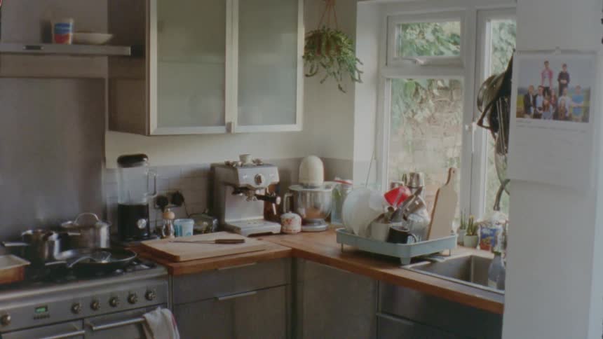 A small kitchen corner with dishes and other equipment on the counter