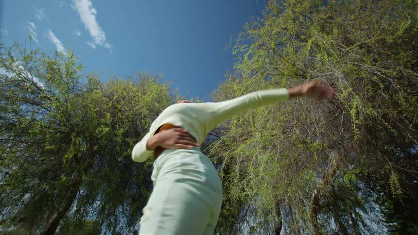 Young woman doing modern dance freestyle in the park during the day