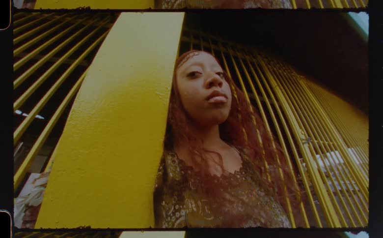 A woman is leaning by the fence