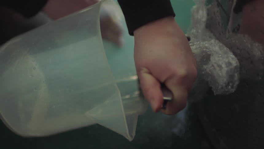 Person turns release to let liquid flow into plastic pitcher