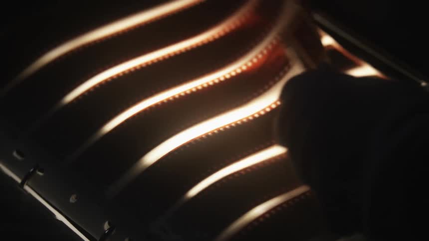 A person flipping through a binder filled with film
