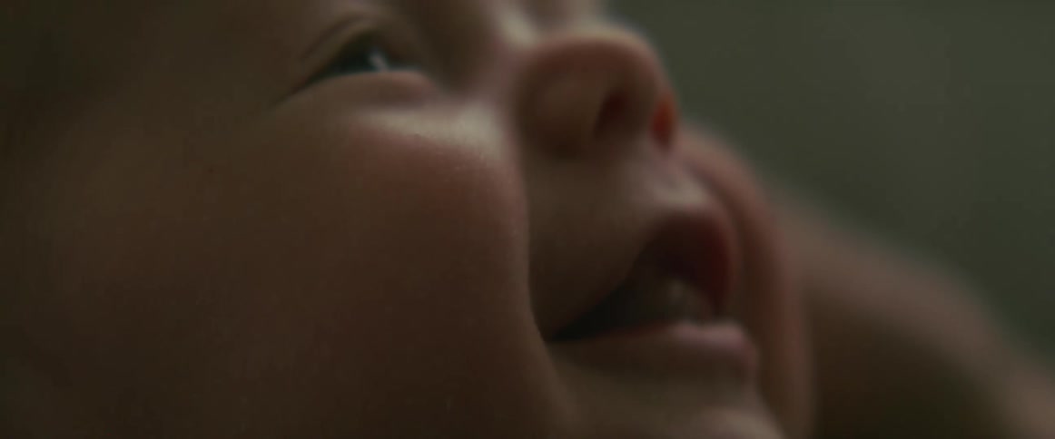 Baby smiles while looking upward