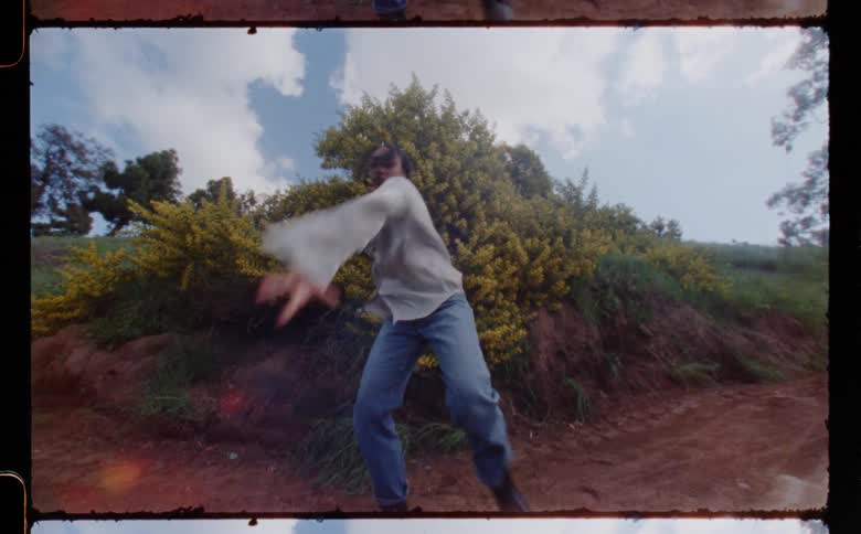 A woman is dancing outdoors