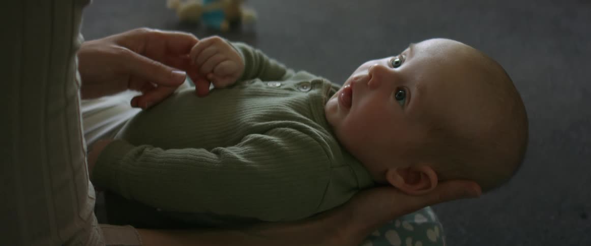 A mother is holding her baby