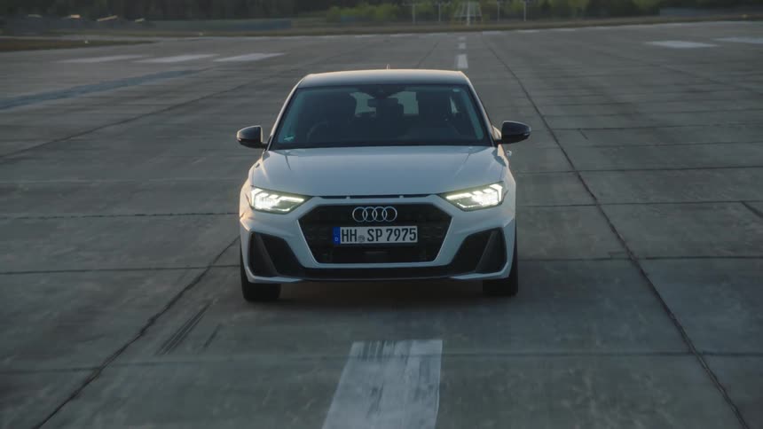 A car driving on pavement during the day
