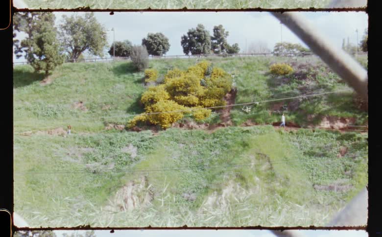Two people walk on the hill in the film