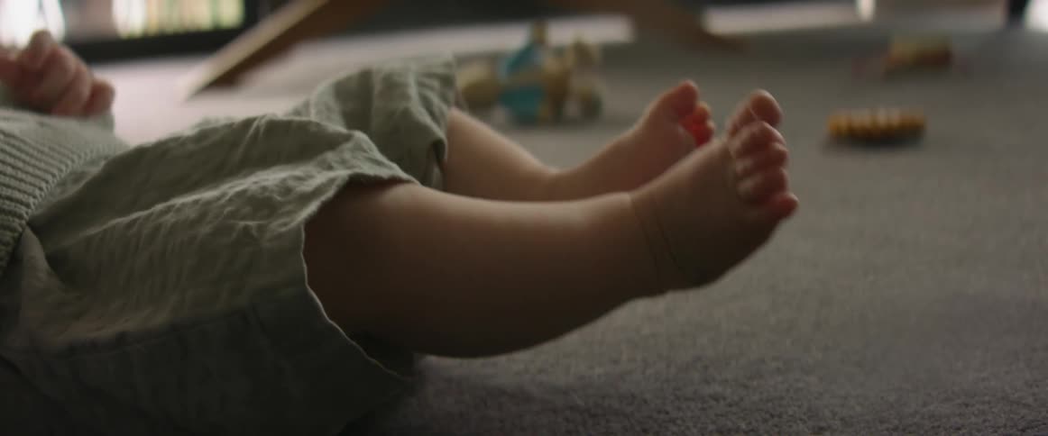 Baby with shorts lying on floor moves legs