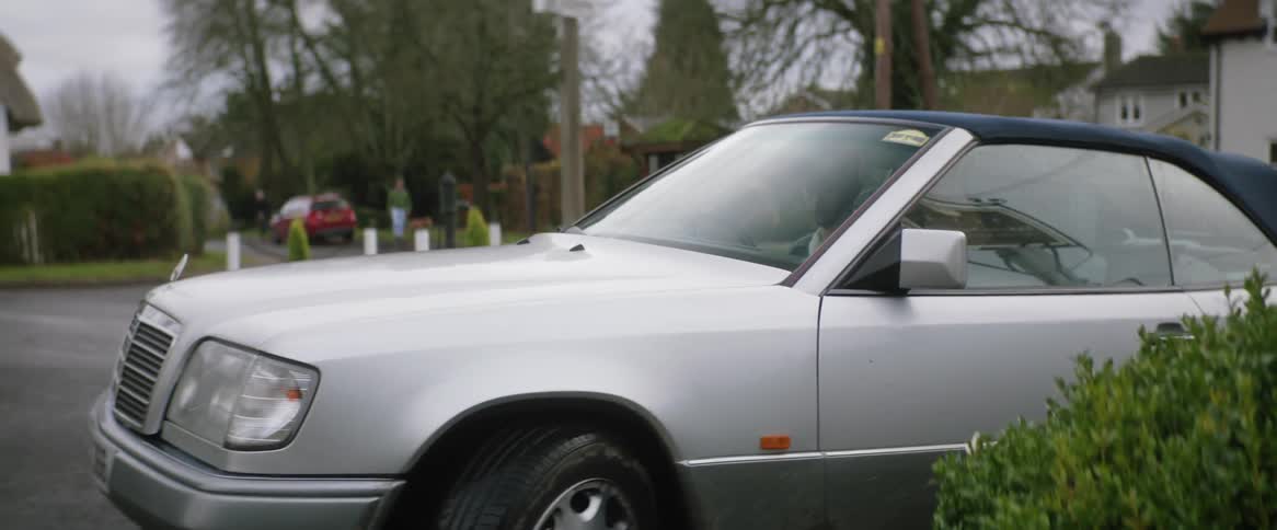 Driver parks car on side of street across from houses
