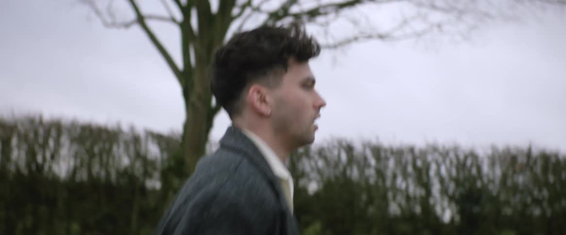An up close of a mans face while he jogs