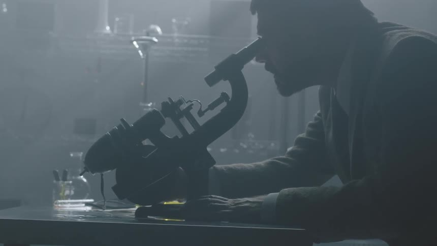 A man uses a microscope