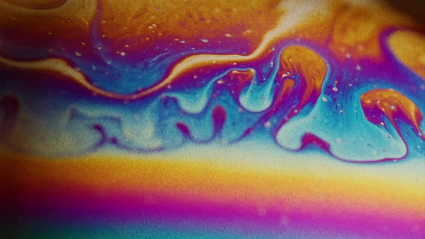 The rainbow colored liquid moves around