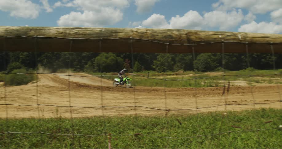 A person does a jump on their dirt bike