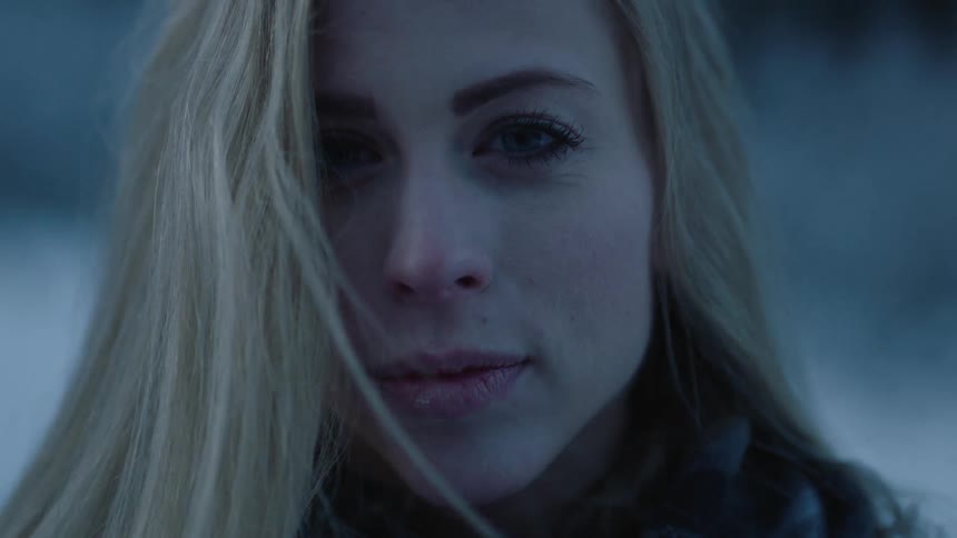 A blonde woman looks up and blinks