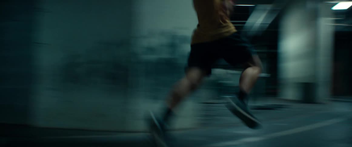 A man running fast on an indoor track