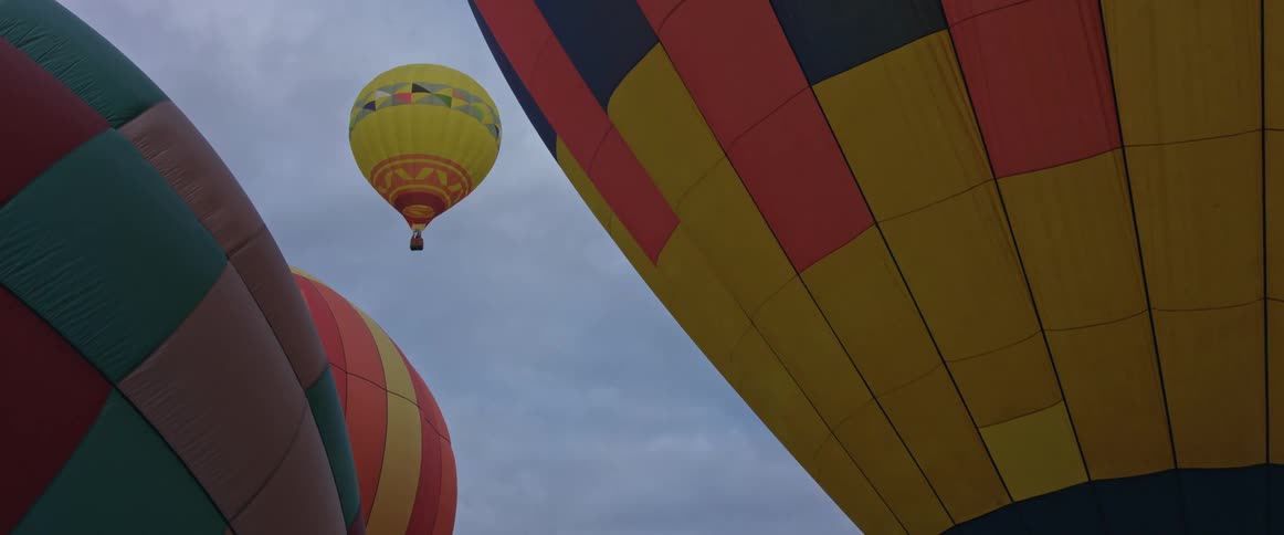 The hot air balloons fly in the sky