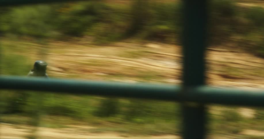 A person riding a dirt bike and jumping it on a dirt track