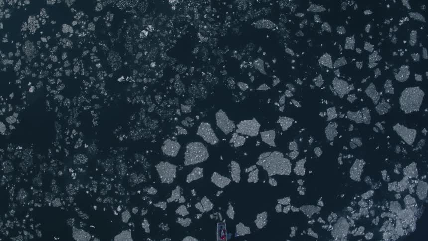 A boat travels through icy water