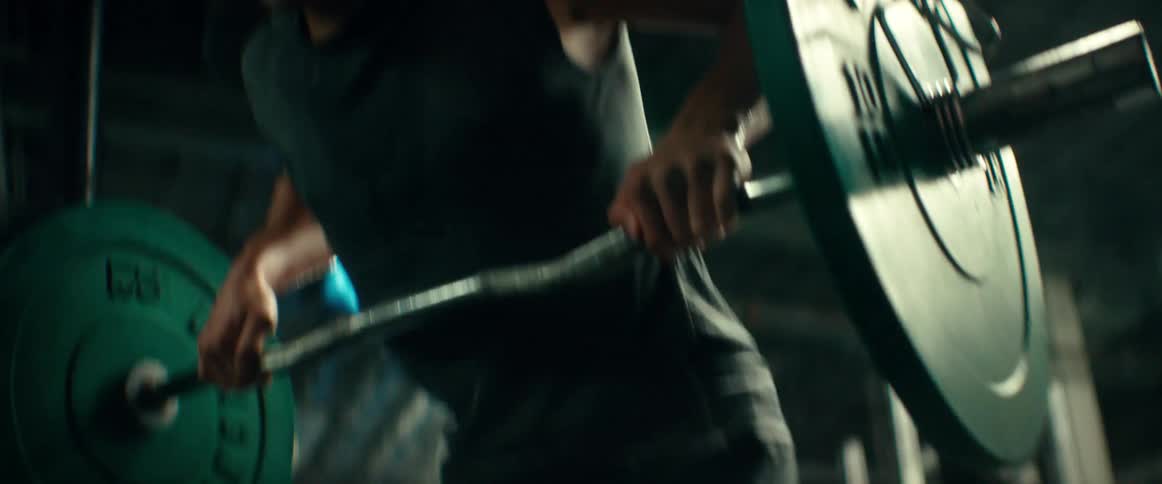 A man is lifting weights in the gym