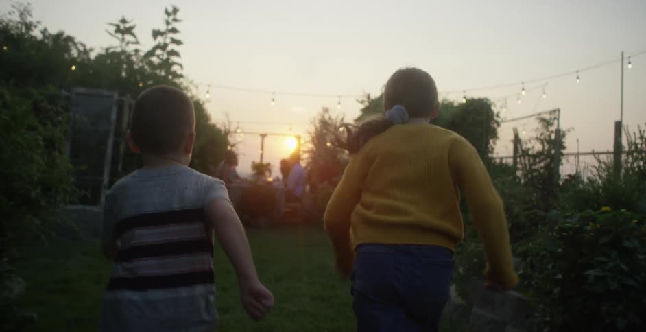 A brother and sister run racing against each other