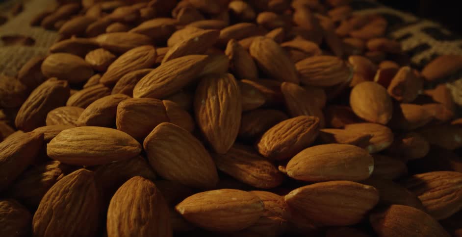 Light shines on almonds piled in a basket