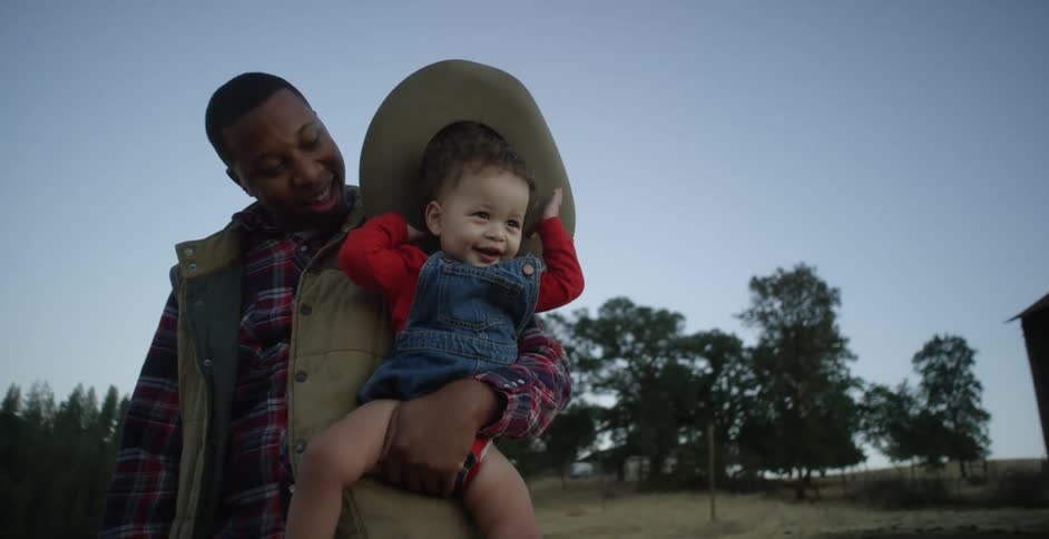 A man is holding a baby in his arms