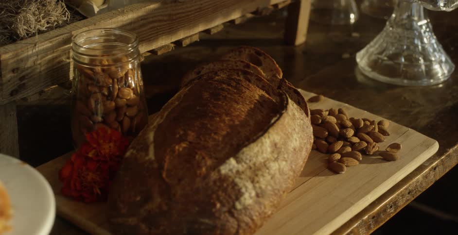 Bread and almonds are on the cutting board