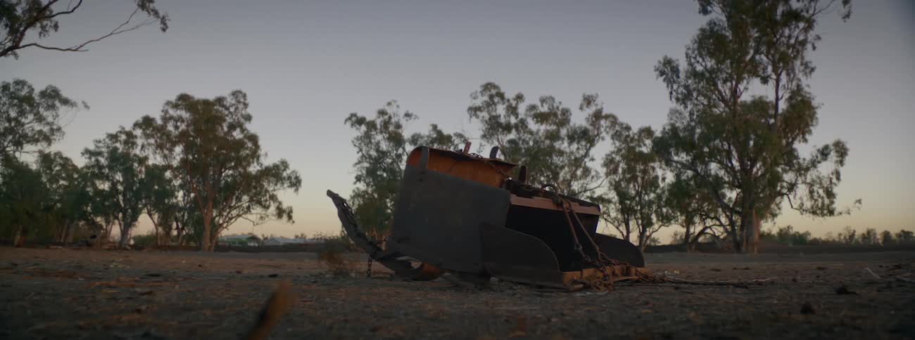 A broken down tractor is parked in an open field