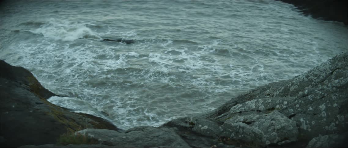 Waves washing ashore a rocky coastline