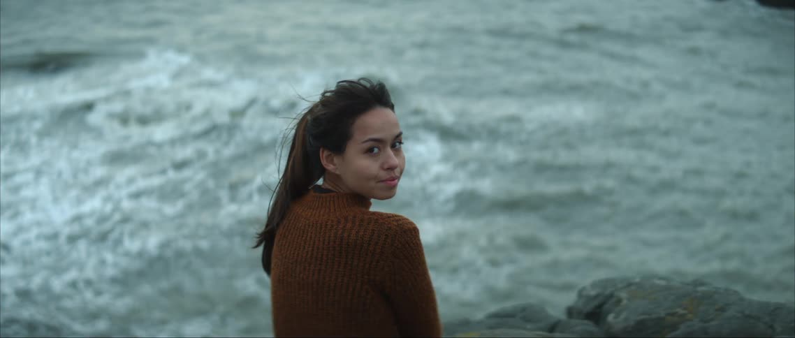 A woman looks out over the water