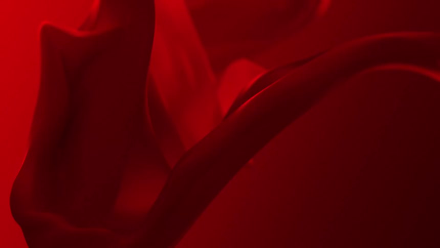 Red fabric swirls against a red background