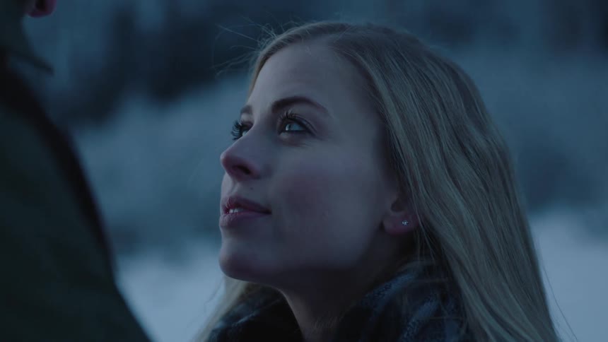 A woman looks up at a man