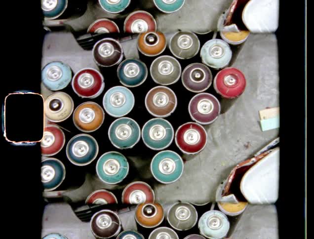 Cans from different colors sit on floor in group near a paint sample