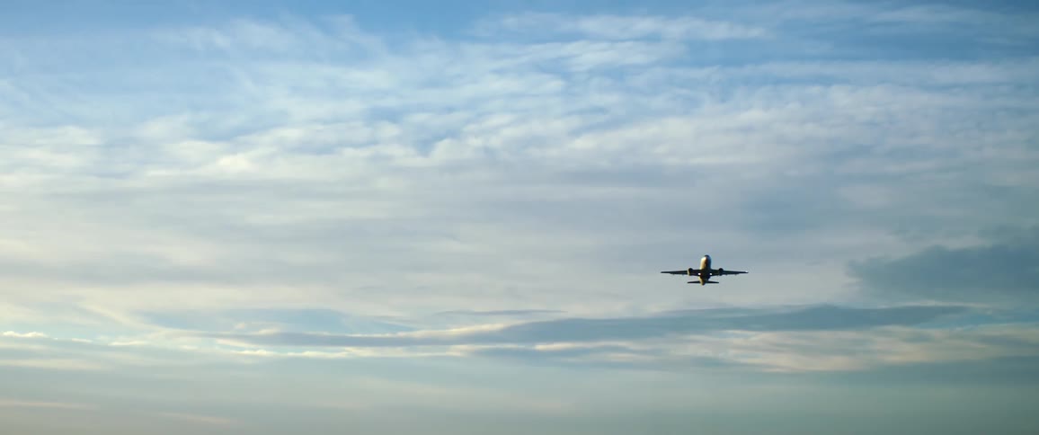 Commercial airplane takes off from an airfield at morning