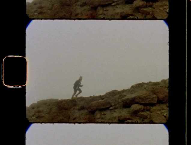A person running up a rocky mountain