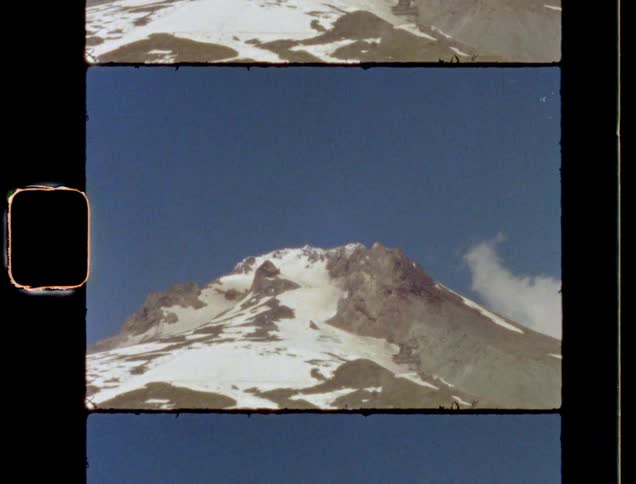 Film footage of a mountain during winter is displayed